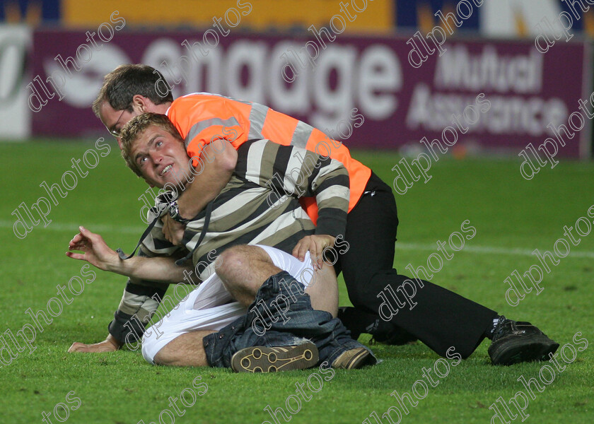 hullfc-bradford13 
 stewards stop a streaker at the final whistle